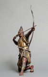 A bronze figure of a Samurai warrior resting on one knee while tensioning a bow