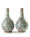 A pair of Chinese famille rose celadon-ground slip-decorated bottle vases