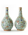 A pair of Chinese famille rose celadon-ground slip-decorated bottle vases