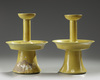 A pair of Chinese yellow-glazed candlestick holders