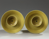 A pair of Chinese yellow-glazed candlestick holders
