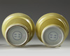 A pair of Chinese yellow-glazed candlestick holders